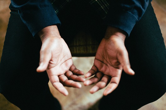 praying hands in lap